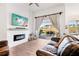 Living room with fireplace, leather couches, and sliding doors to patio at 2937 Bella Flore Ter, New Smyrna Beach, FL 32168