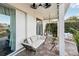 Relaxing patio with a couch, hanging chair, and ceiling fans at 2937 Bella Flore Ter, New Smyrna Beach, FL 32168