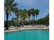 Relaxing community pool with swaying palm trees, ample lounge chairs, and clear blue water for residents enjoyment at 2937 Bella Flore Ter, New Smyrna Beach, FL 32168