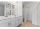 Double vanity bathroom with white cabinets and a shower at 3142 Viceroy Ct, Poinciana, FL 34759