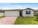 One-story house with a two-car garage and brick paver driveway at 3142 Viceroy Ct, Poinciana, FL 34759