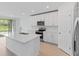 Modern kitchen with white cabinets, stainless steel appliances, and an island at 3142 Viceroy Ct, Poinciana, FL 34759