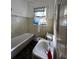 Bathroom with a classic white tub, toilet and sink at 315 Smith Ave, Lake Hamilton, FL 33851