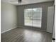 Bright bedroom with wood-look floors and large window at 3209 Windover Ave, Kissimmee, FL 34741