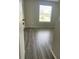 Spacious bedroom featuring wood-look floors and a window at 3209 Windover Ave, Kissimmee, FL 34741