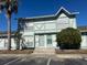 Two-story townhouse with light green exterior and landscaping at 3209 Windover Ave, Kissimmee, FL 34741
