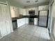 Modern kitchen with white cabinets and granite countertops at 3209 Windover Ave, Kissimmee, FL 34741