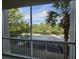 View from screened balcony overlooks trees and parking lot at 3341 Whitestone Cir # 205, Kissimmee, FL 34741