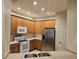 Modern kitchen, stainless steel appliances and wood cabinets at 3341 Whitestone Cir # 205, Kissimmee, FL 34741