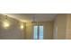 Bright living room featuring double doors and neutral walls at 3341 Whitestone Cir # 205, Kissimmee, FL 34741
