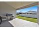 Covered back patio with a grill overlooking the yard, perfect for outdoor entertaining at 434 Panaro Ln, Haines City, FL 33844