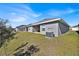 Backyard featuring a well-maintained lawn and a modern home with a covered patio at 434 Panaro Ln, Haines City, FL 33844