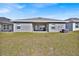Backyard featuring a well-maintained lawn, with an outdoor grill on a patio at 434 Panaro Ln, Haines City, FL 33844