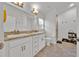 Double sink bathroom with a shower and tiled floors. The room is brightened with two vanity lights at 434 Panaro Ln, Haines City, FL 33844