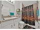 Cozy bathroom featuring a tub with shower, floral shower curtain, and a sink with white cabinets at 434 Panaro Ln, Haines City, FL 33844