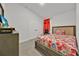Cozy bedroom with floral bedding, neutral walls, and ample closet space at 434 Panaro Ln, Haines City, FL 33844