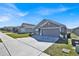 Street view of gray single-story home with well-kept lawn and manicured landscaping at 434 Panaro Ln, Haines City, FL 33844