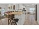 Bright kitchen with bar seating, and white cabinets at 434 Panaro Ln, Haines City, FL 33844