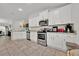 Bright kitchen with stainless steel appliances, white cabinets, and tiled floors at 434 Panaro Ln, Haines City, FL 33844