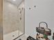 Tiled walk-in shower featuring a showerhead and glass doors in a well-lit bathroom at 434 Panaro Ln, Haines City, FL 33844