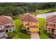 Two-story house with a red tile roof, next to a lake at 4439 Shiva Loop, Kissimmee, FL 34746