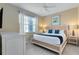 Bedroom with king-size bed and light decor at 4439 Shiva Loop, Kissimmee, FL 34746