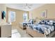 Bedroom with two twin-size beds and blue bedding at 4439 Shiva Loop, Kissimmee, FL 34746