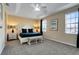 Main bedroom with king bed, bench, and ceiling fan at 4439 Shiva Loop, Kissimmee, FL 34746