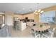 Modern kitchen with island, breakfast bar, and dining table at 4439 Shiva Loop, Kissimmee, FL 34746