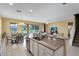 Open kitchen features granite island, stainless steel appliances, and views to backyard at 4439 Shiva Loop, Kissimmee, FL 34746