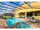 Inviting pool and spa with large patio and lake view at 4439 Shiva Loop, Kissimmee, FL 34746