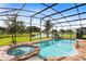 Relaxing screened-in pool and spa with lake view at 4439 Shiva Loop, Kissimmee, FL 34746