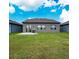 Large backyard with ample green space, a small patio, and an open view, perfect for entertaining and relaxation at 446 Citrus Isle Loop, Davenport, FL 33837