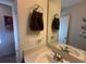 Bright bathroom with white sink, granite countertop and a decorative mirror at 446 Citrus Isle Loop, Davenport, FL 33837