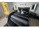 Comfortable bedroom featuring a black upholstered bed, neutral walls, and stylish bedside decor at 446 Citrus Isle Loop, Davenport, FL 33837