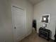 Well-lit bedroom corner featuring a modern bedside table, mirror, and neutral decor at 446 Citrus Isle Loop, Davenport, FL 33837