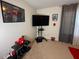 A bedroom with a Spiderman theme, featuring a wall-mounted TV, posters, and decor at 446 Citrus Isle Loop, Davenport, FL 33837