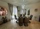 Elegant dining room with a glass table and brown leather chairs at 446 Citrus Isle Loop, Davenport, FL 33837