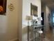 Bright entryway with mirrored vanity and elegant lighting at 446 Citrus Isle Loop, Davenport, FL 33837