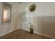 Hallway featuring neutral carpet and decor with framed mirror and gold flower decoration above a small closet at 446 Citrus Isle Loop, Davenport, FL 33837