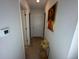 Light hallway with two doors and religious artwork at 446 Citrus Isle Loop, Davenport, FL 33837