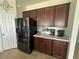 A kitchen featuring stainless steel Samsung appliances and wooden cabinets with gold trim at 446 Citrus Isle Loop, Davenport, FL 33837