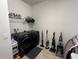 Efficient laundry room with modern washer and dryer, ample storage, and tiled flooring at 446 Citrus Isle Loop, Davenport, FL 33837