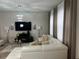 Stylish living room featuring a modern white sectional, glass coffee table, fireplace, and contemporary lighting at 446 Citrus Isle Loop, Davenport, FL 33837