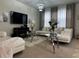 Spacious living room with white couches and large TV at 446 Citrus Isle Loop, Davenport, FL 33837