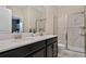 Bathroom with double vanity, marble shower, and tile flooring at 4575 Narrative Ln, Kissimmee, FL 34746