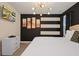 King-size bed in a bedroom with black and white striped walls, and a modern chandelier at 4575 Narrative Ln, Kissimmee, FL 34746