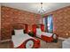 Two twin beds in a ' bedroom with a brick feature wall at 4575 Narrative Ln, Kissimmee, FL 34746