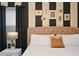 King-size bed with black and white striped walls, and modern decor at 4575 Narrative Ln, Kissimmee, FL 34746