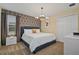 Spacious bedroom with a king-size bed, geometric wallpaper, and modern chandelier at 4575 Narrative Ln, Kissimmee, FL 34746